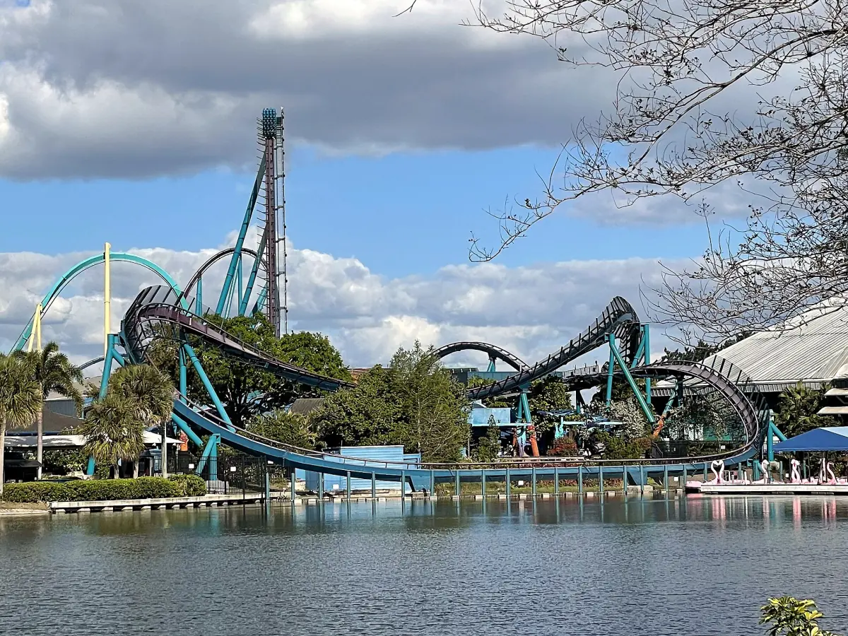 A roller coaster track and lift hill across a lake in Orlando